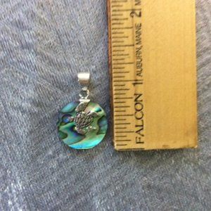 Sterling Silver Turtle upon a circular Albone Shell Pendant